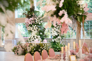 Class Event Rentals Pink Garden Wedding setting with luxurious flowers and Rosabelle chairs seen from front