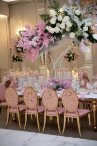 Class Event Rentals Rosabelle Chairs in pink with gold rose accent and Athena table at wedding with floral centerpiece