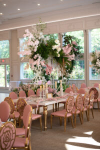 Class Event Rentals Rosabelle Chairs in pink and gold and Athena table in wedding with floral centerpiece