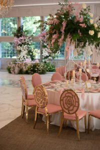 Class Event Rentals Rosabelle Chairs in pink and gold wedding seating area with flowers and windows