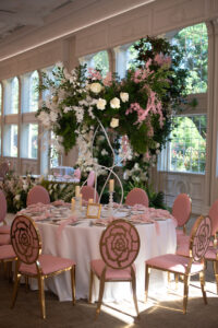 Class Event Rentals Rosabelle Chairs in pink and gold wedding seating area with floral backdrop