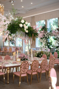 Class Event Rentals Rosabelle Chairs in pink and gold and Athena table in wedding dining area with floral cascades