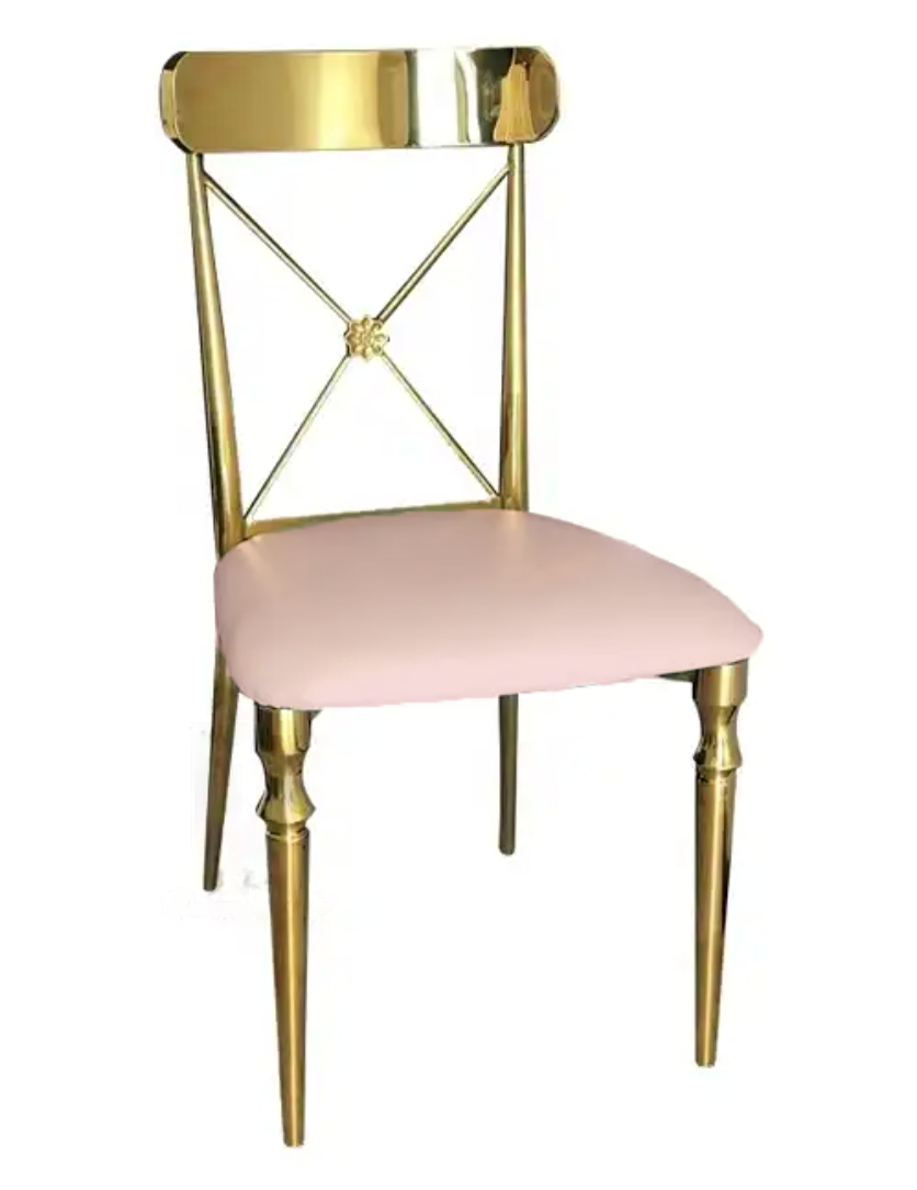 An elegant chair featuring a glossy golden frame with a unique x-shaped back design, and a soft pink cushioned seat.
