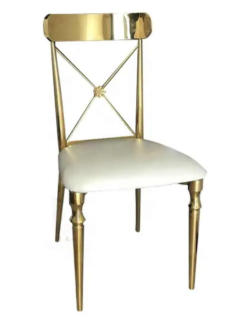 An elegant gold chair with a white cushioned seat and intricate backrest design featuring a cross and loop pattern.