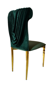 An elegant chair with dark green velvet draped over its back and gold legs, isolated on a white background.