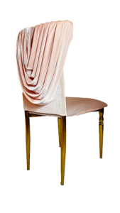 Elegant dining chair with glossy, dark wooden legs and a light pink velvet seat. a draped, soft pink fabric elegantly flows down the chair's back, creating a luxurious, textured look.
