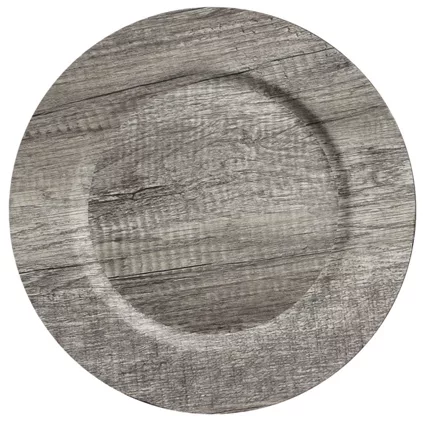 A round, wooden charger plate with a noticeable circular pattern in a slightly darker shade, creating a subtle ring on the textured gray wood grain.