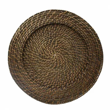 A round, woven wicker charger plate with a tightly spiraled design, featuring various shades of brown. The texture is intricate and the pattern is concentric circles.