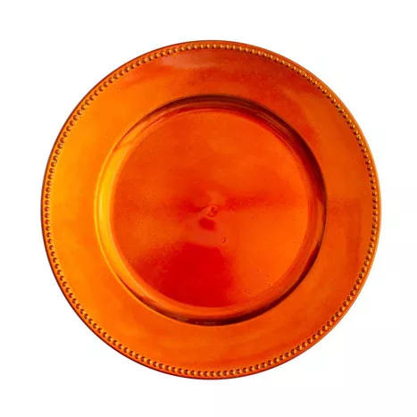 An empty, bright orange ceramic charger plate with a decorative embossed rim, isolated on a white background.
