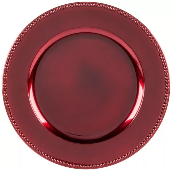 A deep red, glossy charger plate with a raised rim and subtle decorative beading along the edge, viewed from above on a white background.