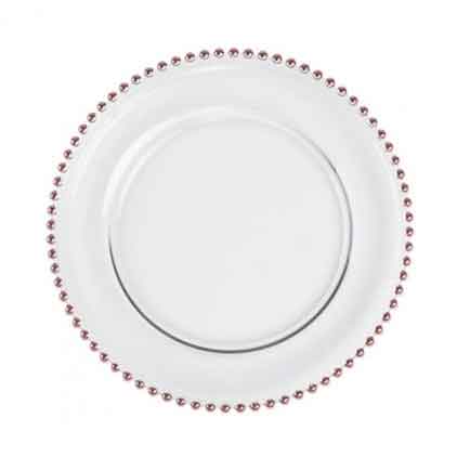 A plain white ceramic charger plate with a decorative border of small red gems, centered on a light background.
