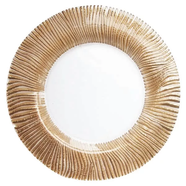 A decorative gold charger plate with a textured, radiating groove design and a smooth white center.