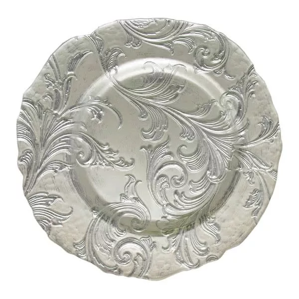 An ornate silver charger plate with a detailed embossed design featuring flowing swirls and leaf-like patterns, giving it a luxurious and antique appearance.